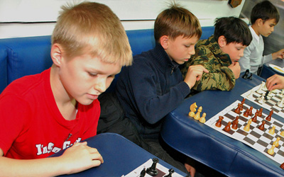 Russian kids playing chess, photo credit Commander, U.S. 7th Fleet on Flickr